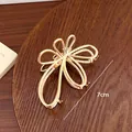 Elegant gold metal claw clip in Korean style with hollow alloy heart design, 7cm - Large Floral Design (9cm) For Sizes 18-39 / Factory Direct