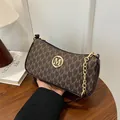 Elegant brown crescent underarm bag with golden M logo and monogram letter print pattern - One Size / Coffee
