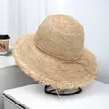 Detailed macro view of high quality fine raffia woven sun hat with frayed brim design - Fringe Bow Style (LF1047) / Natural Wood Color