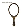 Vintage oval handheld makeup mirror with ornate bronze finish - Vintage / Bronze