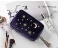 Detail view of purple velvet cosmetic bag featuring gold star moon embroidery and tassel - Clutch Small Pouch / Deep purple