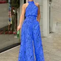 Tuta blu senza maniche con scollo all'americana e stampa di visi astratti neri - Taglia S / Blu zaffiro