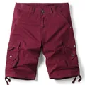 Detailed view of burgundy cargo shorts with multiple utility pockets and hem drawstrings. - 38 / Bottoms / Burgundy