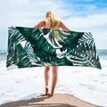 Detail of microfiber beach towel featuring vibrant green tropical leaf patterns - 75x150cm / Tropical Plants