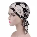 Side view detail of a stylish black and white floral printed turban headscarf for women - One Size / Black Rice Large Flower