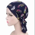 Detail view of a navy blue printed headscarf with colorful feather pattern - One Size / Feather Navy Blue