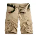 Detailed view of men's khaki cotton cargo shorts featuring multiple pockets and a green belt. - 29 / Creamy Yellow