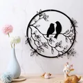 Elegant black metal wall art featuring a circular frame with bird and branch silhouettes - Bird 1