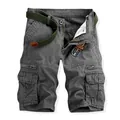 Detail of grey men's cotton cargo shorts featuring multi-pocket design and woven belt. - Soil Army Green