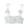 Front view of a white cropped camisole top featuring large 3D floral decorations. - White / S