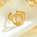 Elegant gold stainless steel open ring featuring intertwined smooth and twisted rope bands - Irregular Double Loop Twist (GJ081)