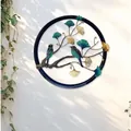 Round iron wall art decoration featuring green birds and golden ginkgo leaves - Tree & Bird
