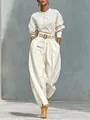 Vista dettagliata di un set coordinato crema con top morbido e pantaloni harem eleganti - Taglia S / Top E Pantaloni / Bianco avorio