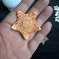 Natural star-shaped sea urchin shell held in hand showcasing unique organic texture - Yellow Starfish (4cm)