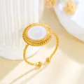 Elegant golden stainless steel twisted open ring featuring a round white glittery inlay - Round Glitter Texture (GJ100)