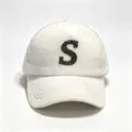 Close-up of a fluffy white faux mink fur baseball cap with a glittery black letter S. - White S-Logo / Adult Size Hat Circumference 58cm Adjustable.