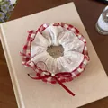 Close-up of red gingham scrunchie with white lace, heart patterns and a red bow. - Scrunchie / Red White Plaid