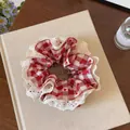 Detail of a red gingham scrunchie with tiny hearts and a white floral lace border. - Four Layer Scrunchie / Red White Plaid