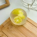 Handmade lemon-scented Vaseline stress relief squishy ball toy on a wooden cutting board - Lemon Vaseline Ball / 6cm / Yellow