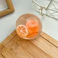 Translucent orange slice squishy toy ball on wooden tray - Tangerine Vaseline Ball / 6cm / Orange