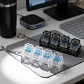 Detail view of 4-key mechanical switch fidget keychain with LED light on a desk mousepad - No Light + Chain / Transparent Black
