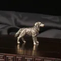 Detailed macro shot of vintage brass sheepdog figurine featuring intricate fur texture - Bronze
