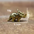 Detail view of brass triceratops dinosaur figurine with weight and size measurements - Triceratops
