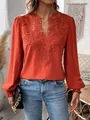 Close-up detail of a burnt orange V-neck blouse featuring intricate floral lace embroidery - S / Tops / Red