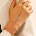Minimalist gold finger bracelet chain featuring turquoise beads for women and girls - Turquoise-Look Beads Style / Gold