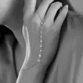 Minimalist silver-tone hand chain ring bracelet featuring sparkling round crystal accents - Multiple Rhinestones Linked Style / Silver