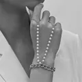 Elegant pearl and chain hand harness bracelet jewelry in a stylish grayscale pose. - Cuban Chain with Double Artificial Pearl Linked Style / Silver