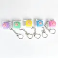 Lot de porte-clés colorés en silicone en forme de patte de chat pour décompresser. - Léger / Jaune
