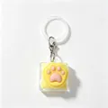 Porte-clés testeur d'axe de clavier mécanique en silicone patte de chat jaune et rose - Anneau de suspension inclus / Léger / Jaune