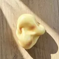 Close-up of a realistic potato-shaped slow rebound squishy toy on a wood surface. - Guangdong Quality Style