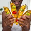 Detailed shot of banana-shaped squishy toy with colorful fruit inclusions for stress relief - Banana Fruit Particles