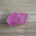 Detail shot of pink glittery 67 shape stress relief squeeze toy on wood table. - Purple