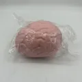 Close-up detail of a pink brain-shaped slow rebound squishy stress ball in clear packaging - Simulated Brain