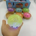 Close-up of a glowing green glitter dumpling squeeze toy held in hand - 8.5cm Gel LED Bun (Glitter)