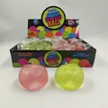 Close-up of apple-shaped maltose squishy stress balls in pink and green with retail box. - Apple / Pink / Light Green