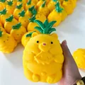 Detailed view of a cute pineapple bear squishy toy held in hand for stress relief - Bagged (Pineapple Bear) / Yellow