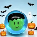Close-up of a blue translucent squeeze toy featuring a green monster head inside - 5.5cm Maltose Pack / Blue Ghost Head