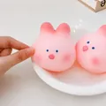 Close-up of cute pink cherry blossom rabbit squishy toy being squeezed for stress relief - Little Rabbit Pig