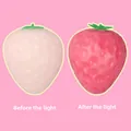 Detail view of the color-changing strawberry squishy toy showing light effects - Color Changing Strawberry