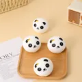 Detailed view of four cute panda head stress relief squishy toys on a small wooden tray - Panda Head Style