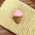 Detail shot of a pink ice cream squishy toy on a yellow checkered cloth background - Pink