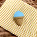 Close-up detail of a blue and tan simulation ice cream squishy toy on checkered cloth - Sky Blue