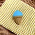 Close-up detail of a blue and tan simulation ice cream squishy toy on checkered cloth - Sky Blue