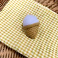 Close-up of a simulation ice cream squishy toy on a yellow checkered cloth - Lavender