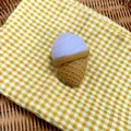 Close-up of a simulation ice cream squishy toy on a yellow checkered cloth - Lavender