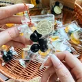 Close-up of a mini simulation blueberry squeeze toy in a clear bag with a silver chain. - Blueberry / 6 Pieces/Pack
